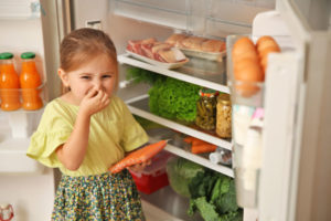 girl with food in refrigerator